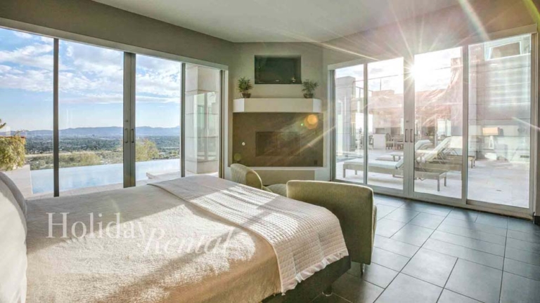 vacation rental bedroom with floor to ceiling windows